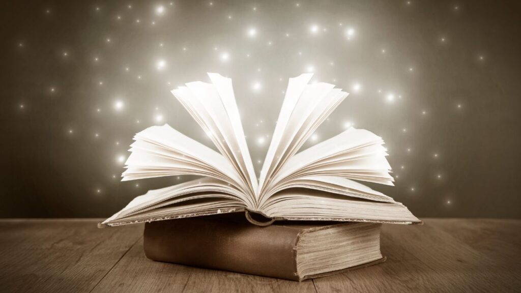 Obrazek przedstawia otwartą książkę, która ma wokół siebie magiczną osłonkę