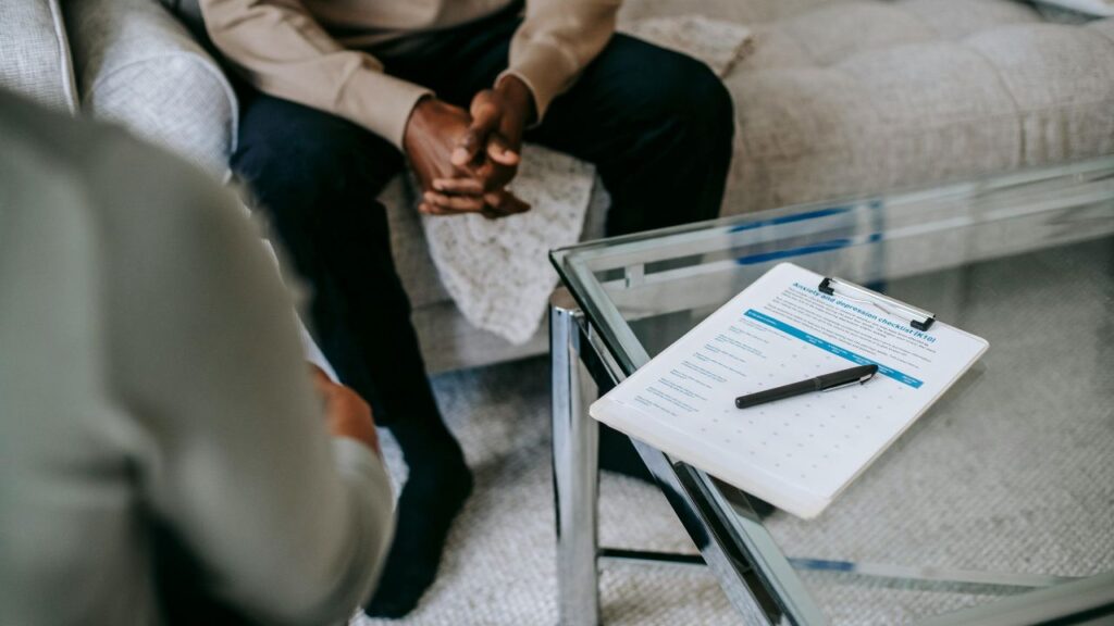 Obrazek przedstawia rozmowę psychologa z pacjentem